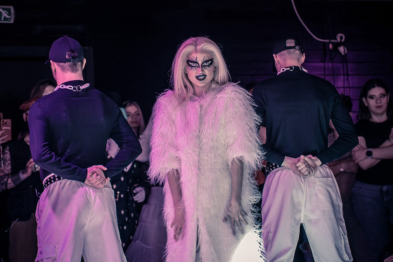 Crowd cheering for a DRAGRIFT artist in a neon-lit venue