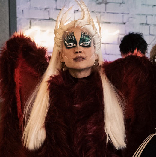 Portrait of judge Spizy G smiling in glam makeup